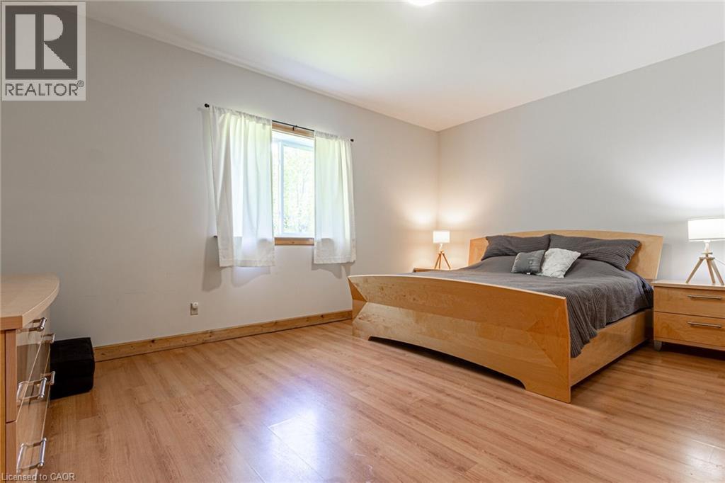 Spacious interior featuring wood-finish flooring, a large window, and light neutral wall colors