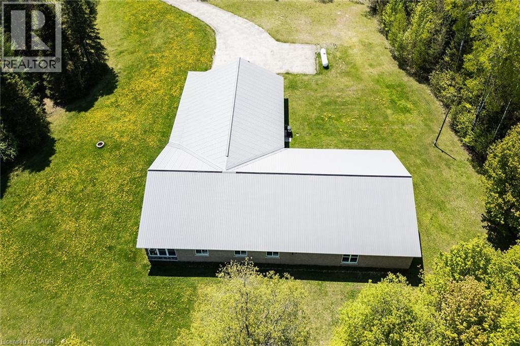 Expansive property featuring a contemporary L-shaped structure with a metal roof