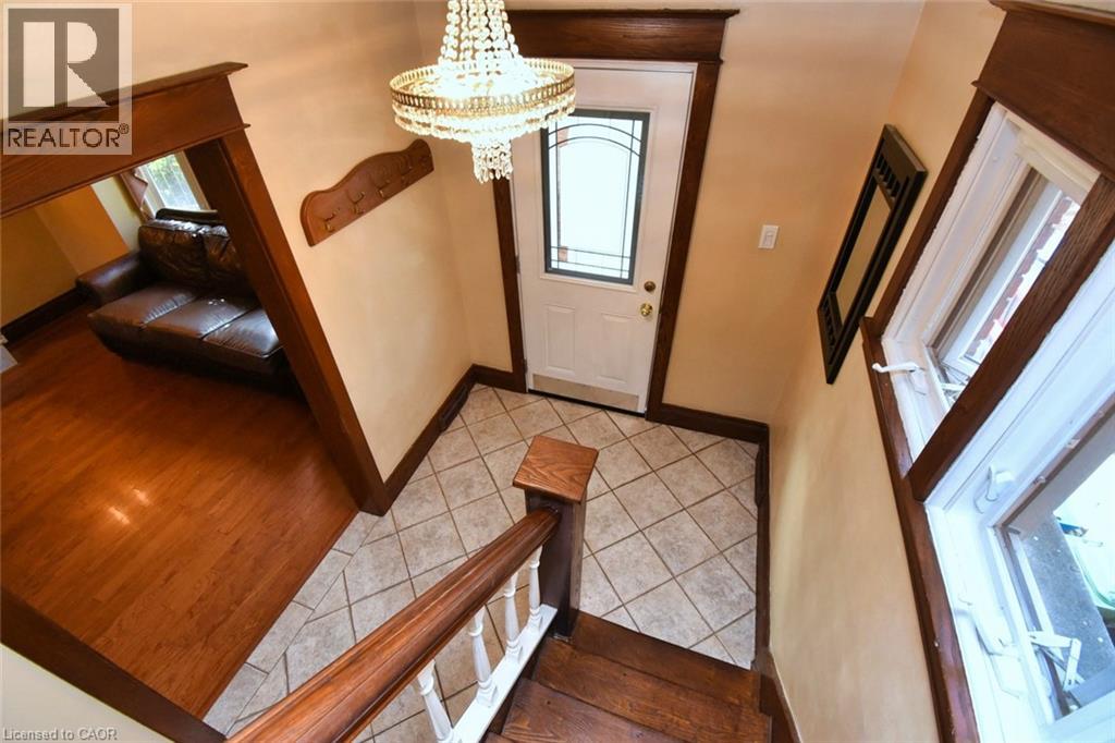 Foyer with ceramic tile flooring and a decorative chandelier