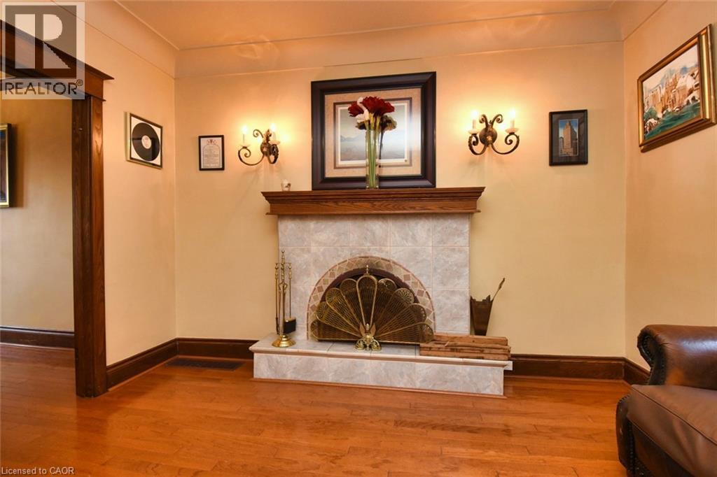 Fireplace featuring a wood mantel, tiled surround, and hearth