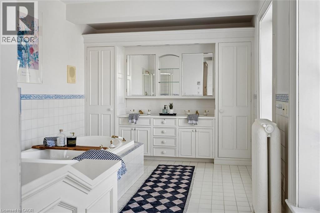 Built-in cabinetry with extensive storage, dual undermount sinks, and two medicine cabinets with mirrored fronts