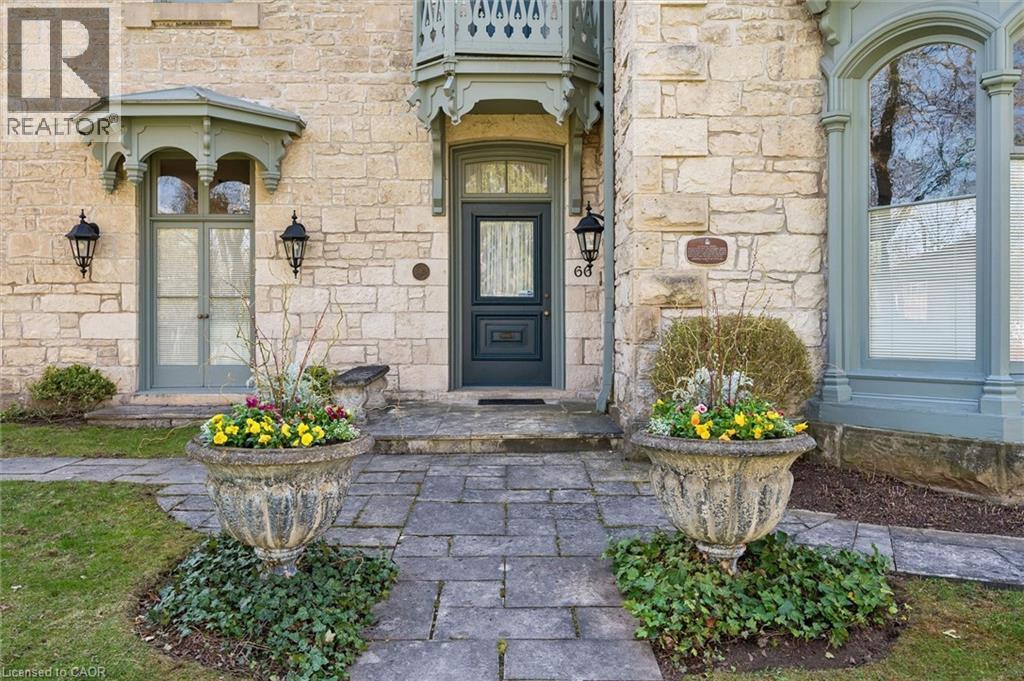 Stone block exterior facade featuring decorative window trim and a stone pathway