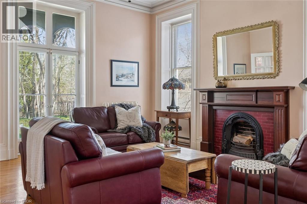 Ornate dark wood fireplace mantel with a red brick surround and cast iron firebox