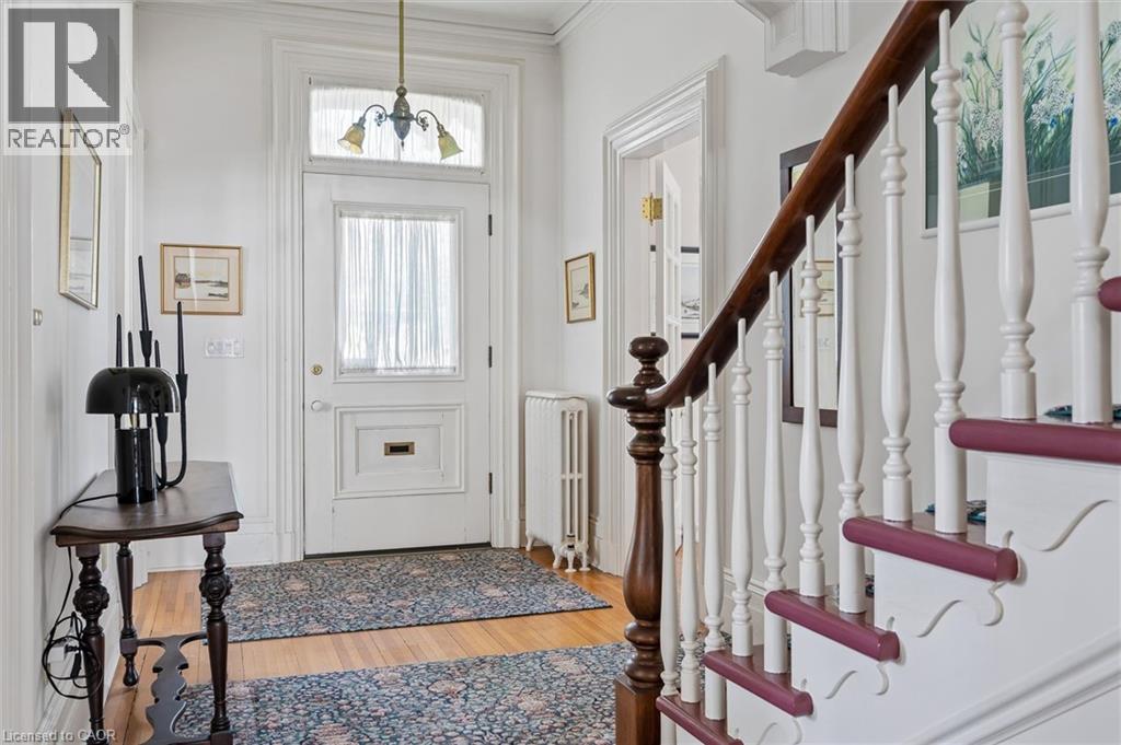 Entryway featuring a classic wooden staircase with white balusters and a dark wood handrail