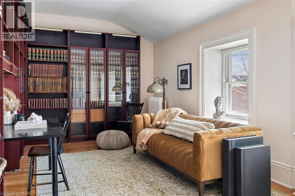 Built-in library shelving with glass-front cabinetry and integrated lighting