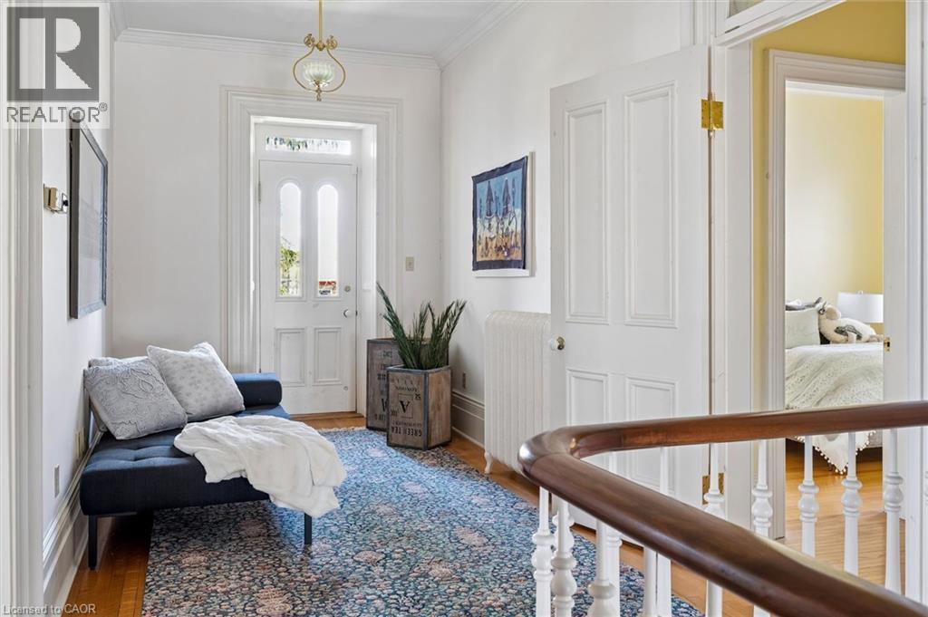 Upper hallway featuring hardwood flooring and a decorative area rug