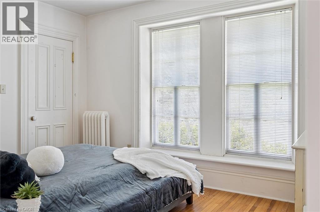 Hardwood flooring complementing a classic paneled door and substantial window trim