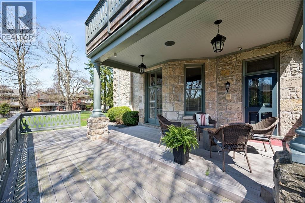 Spacious covered wood-decked porch with stone column accents