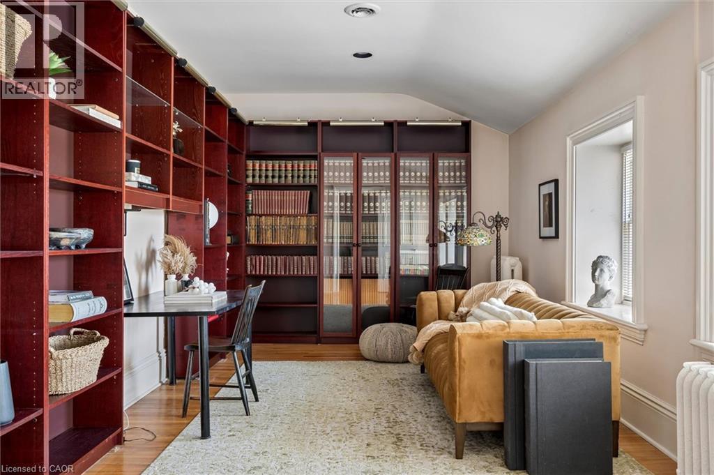 Built-in cherry-toned shelving with adjustable shelves and integrated desk space