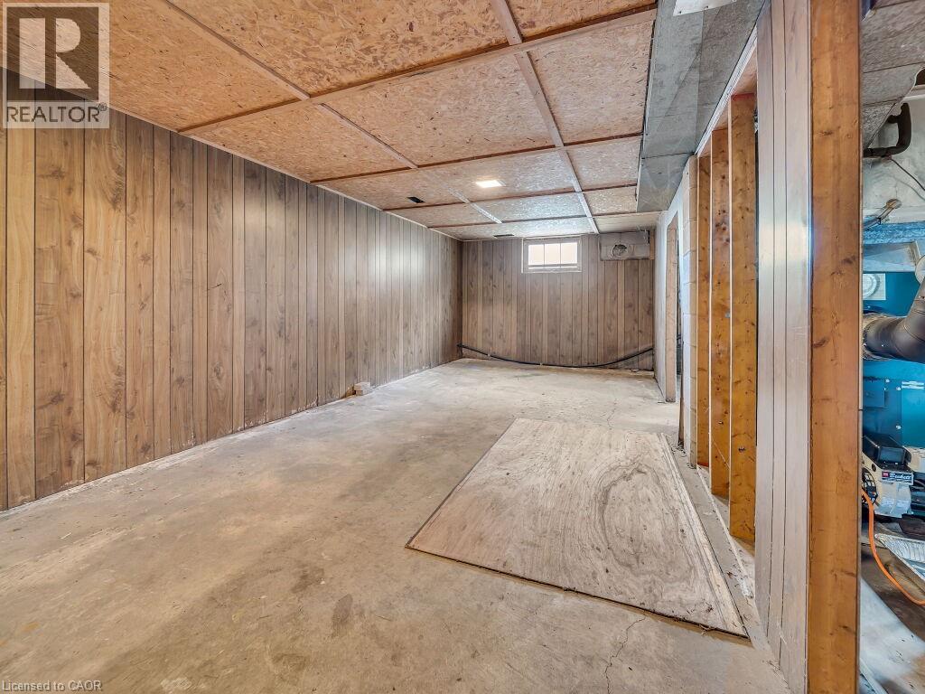 Lower-level interior featuring wood-panel walls and an exposed wood-frame structure