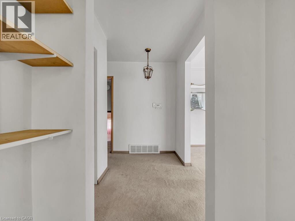 Neutral wall paint, built-in shelving, and a hanging light fixture