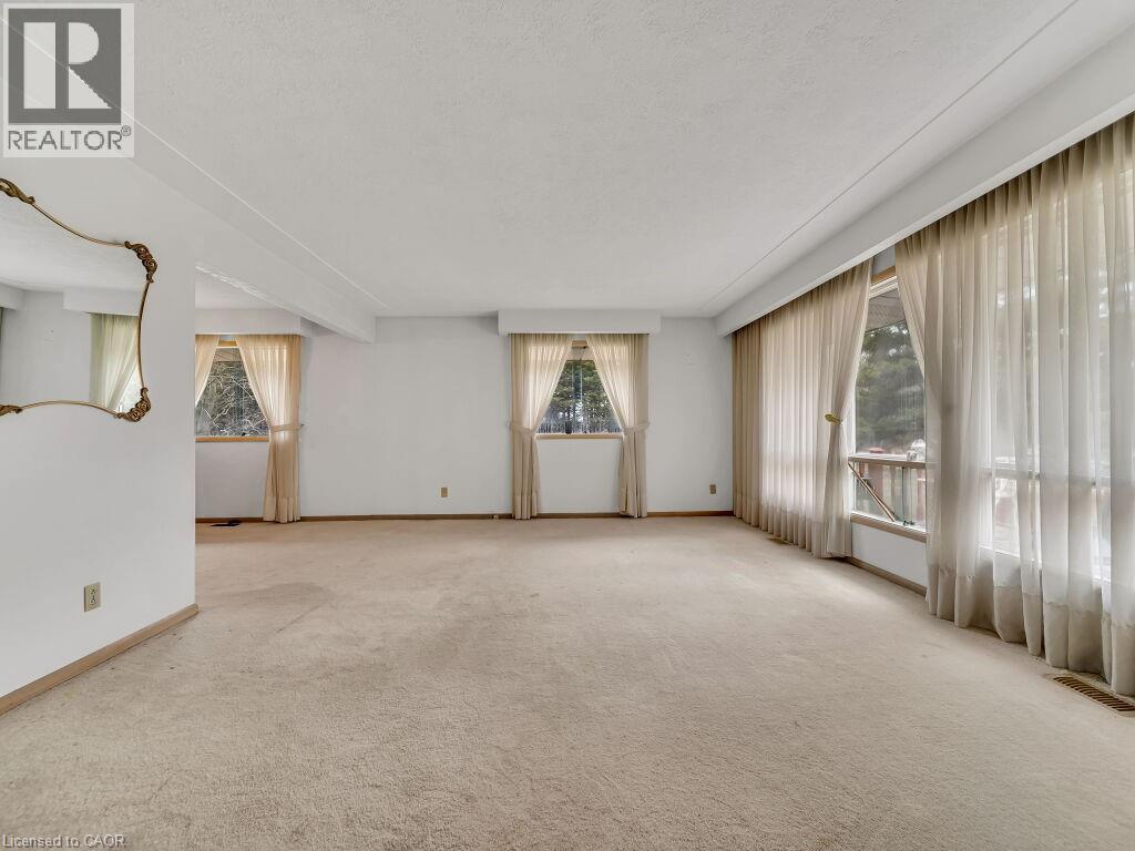 Expansive interior space featuring light-toned carpeting and white walls