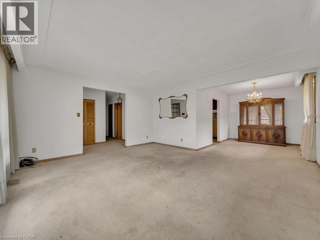 Expansive living area with neutral carpeting and white walls