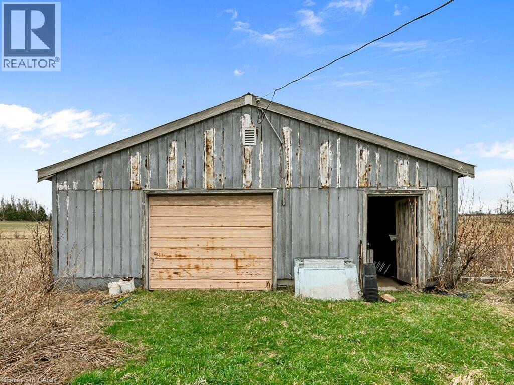 Utility building featuring a single garage door and an additional entry point