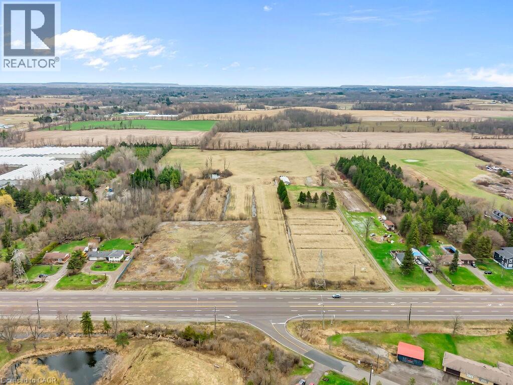 Expansive land parcel featuring direct road frontage, multiple distinct fields, and mature tree lines