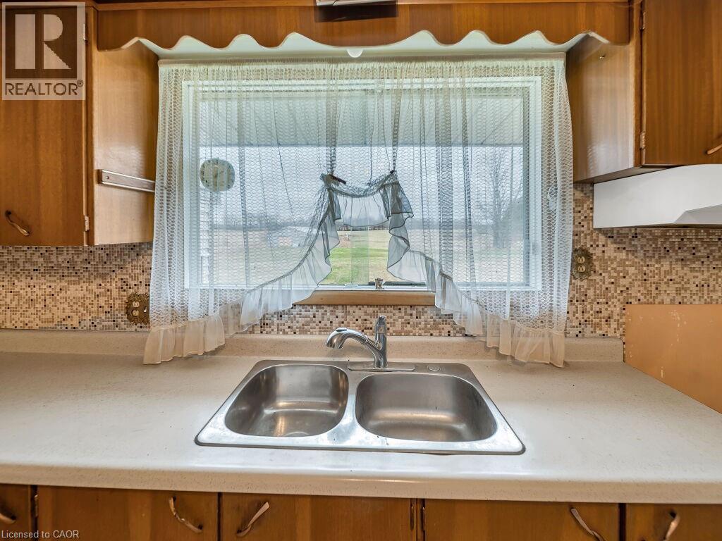 Dual basin stainless steel sink with a chrome faucet set against a light-toned countertop