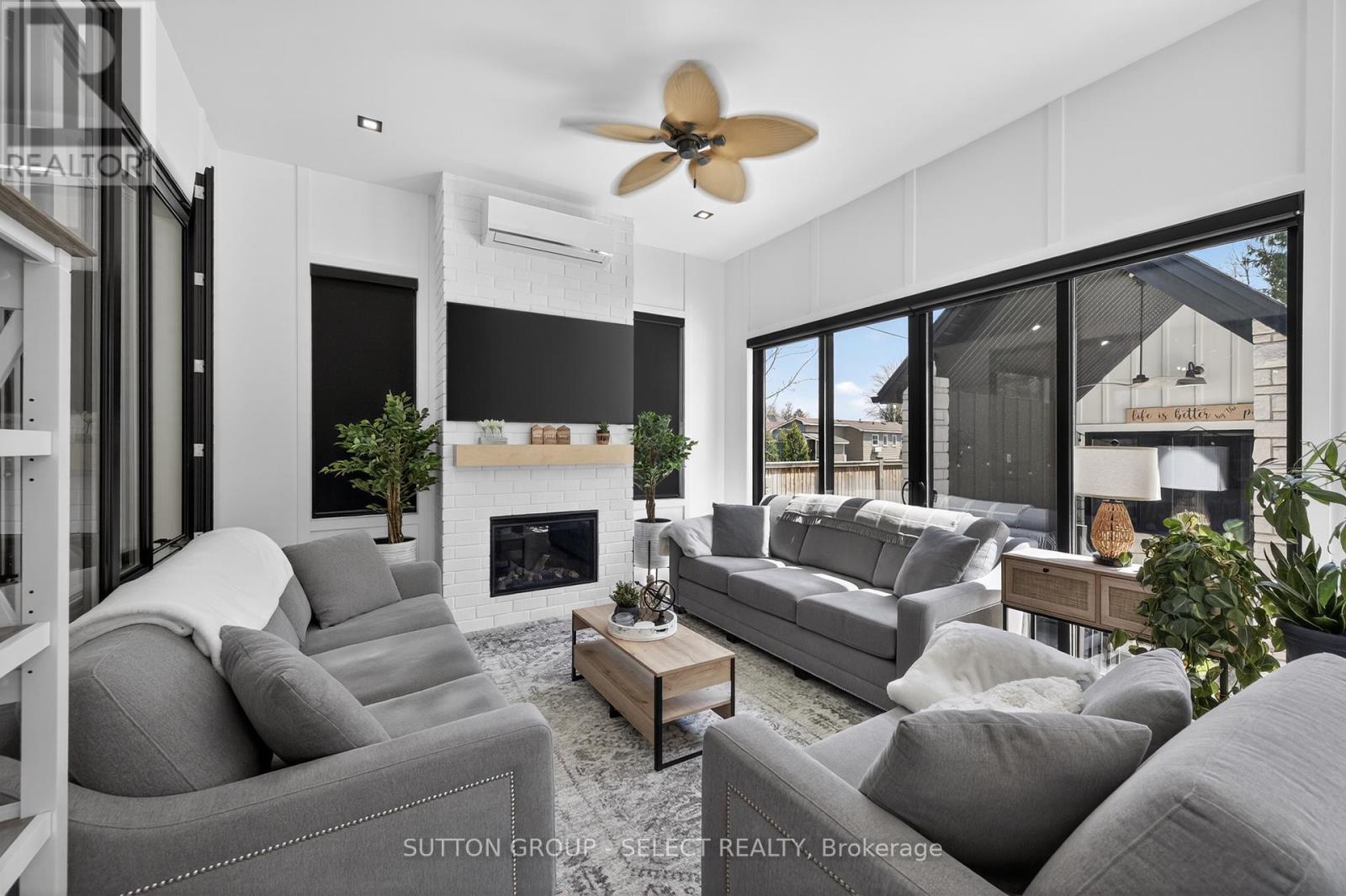 Family room with fireplace & triple sliding doors