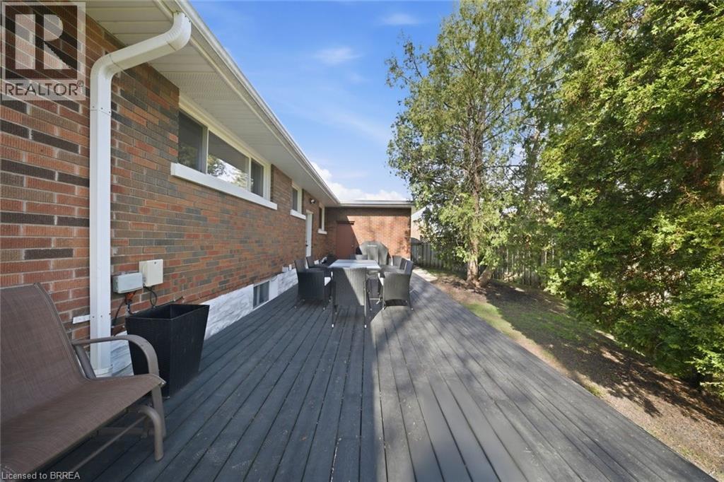 Expansive wood-finish deck with a red brick exterior