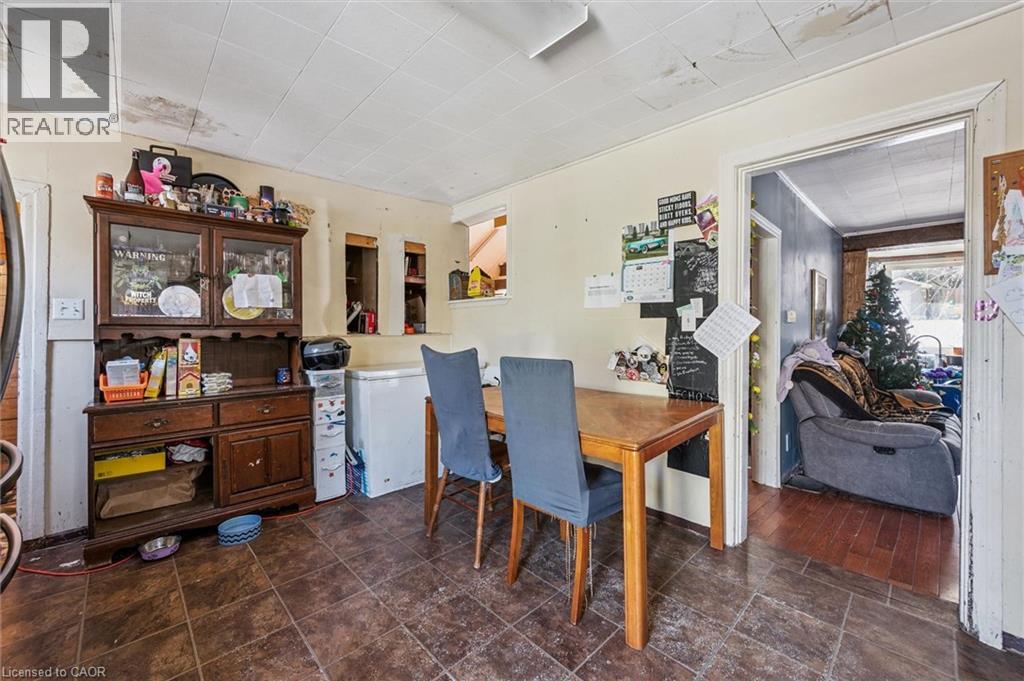 Kitchen area featuring tile flooring, neutral wall tones, and a doorway to an additional room