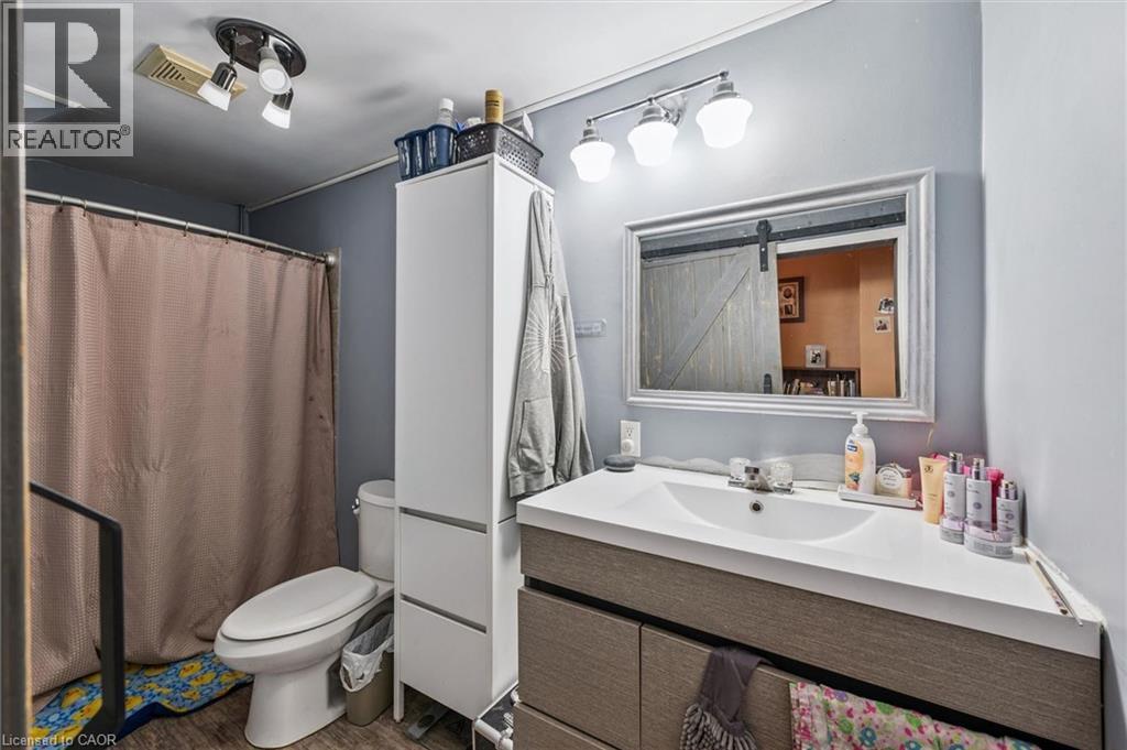 Bathroom featuring a vanity with an integrated sink, a framed mirror, and a track lighting fixture