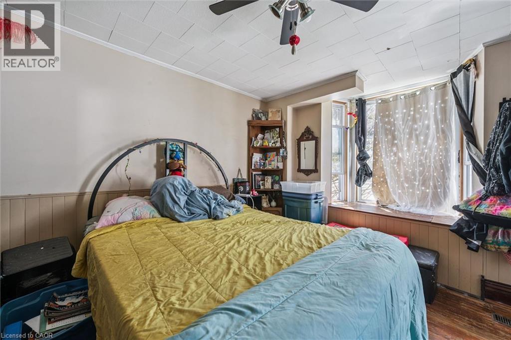Room featuring a bay window, wood-finish flooring, and a ceiling fan