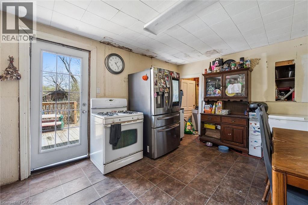 Kitchen space featuring direct outdoor access, a gas range, and tile flooring