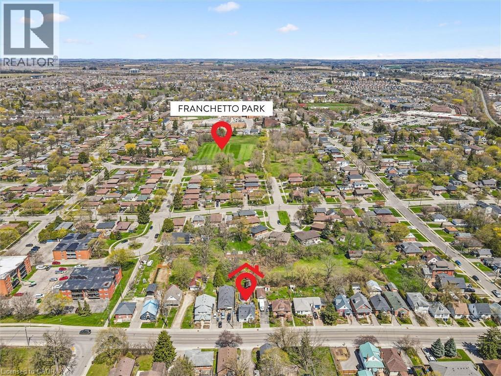 Aerial perspective of a residential neighborhood featuring established homes and mature trees