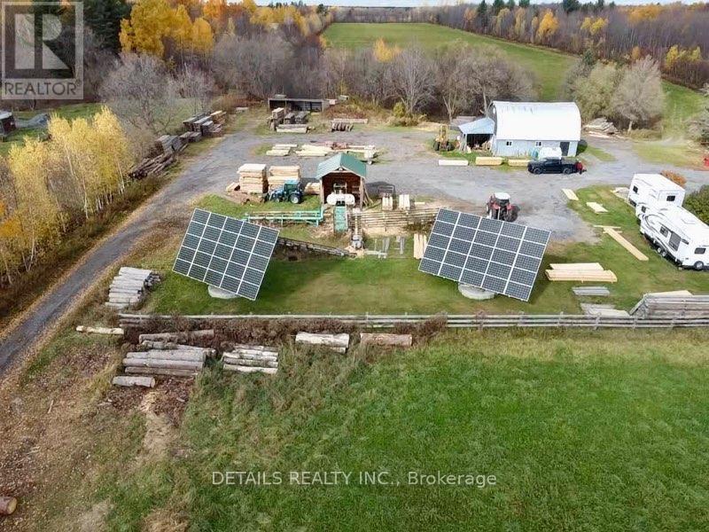 aerial of saw mill, barn, solar & trailer parking