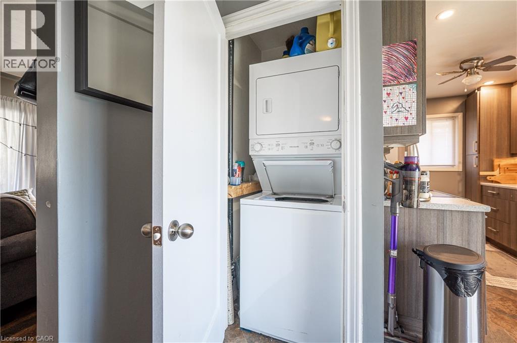 Dedicated laundry area featuring a stacked washer and dryer unit