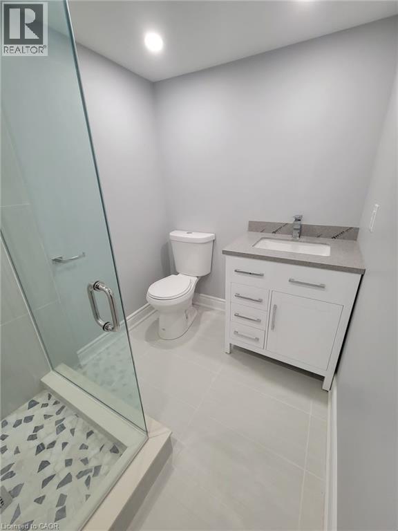Contemporary bathroom featuring a glass-enclosed shower with mosaic tile flooring
