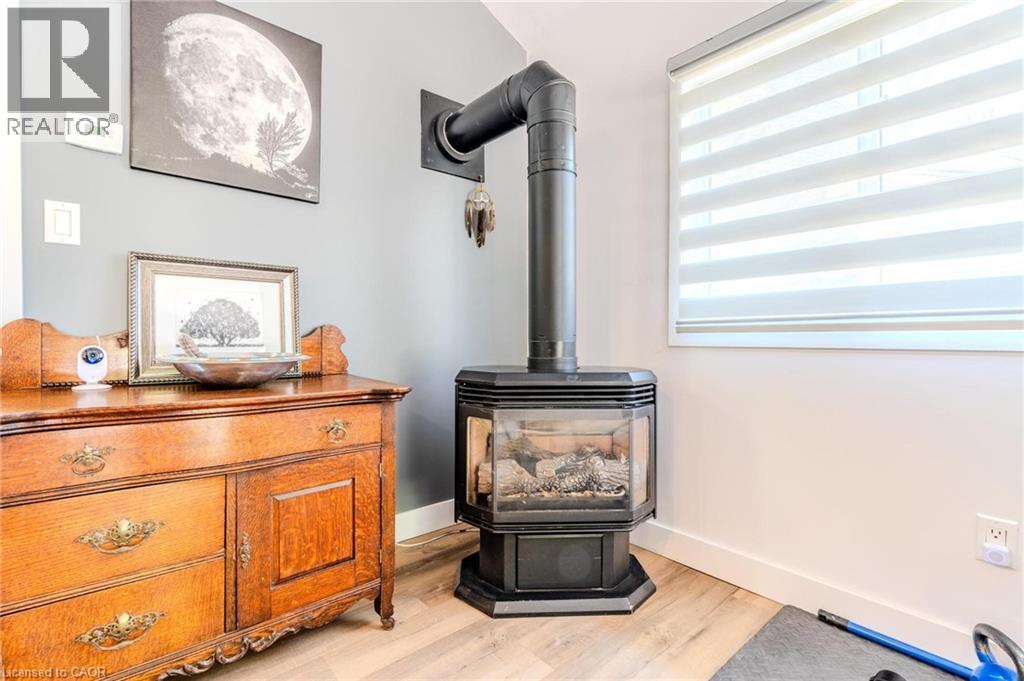 Freestanding fireplace with glass viewing panels and exposed stovepipe