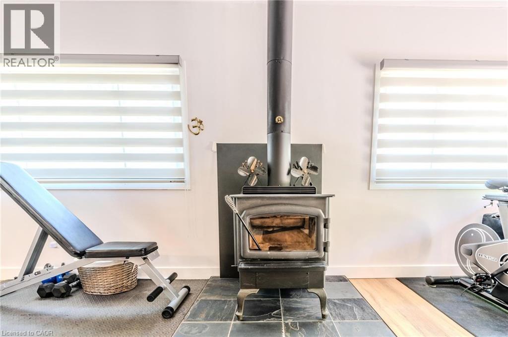 Cast iron wood-burning stove with a slate tile hearth and metal flue