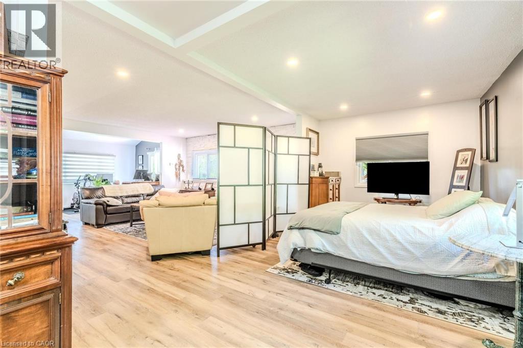 Spacious interior featuring wood-finish flooring, recessed lighting, and a tray ceiling element