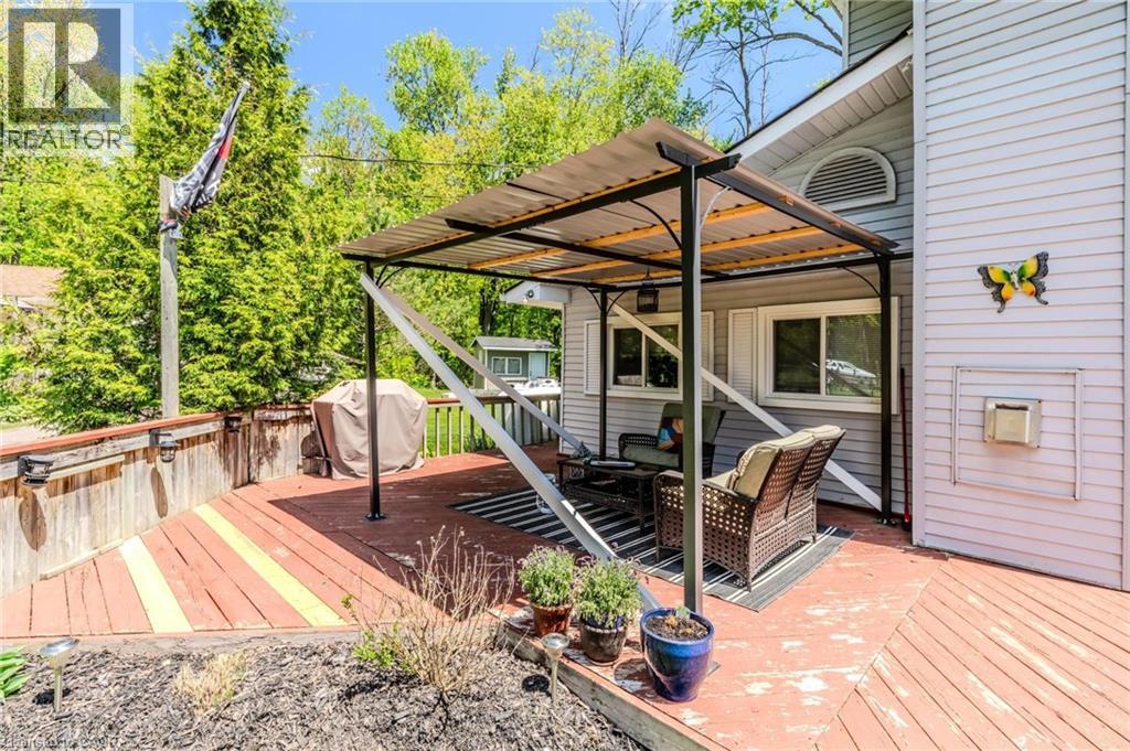 Expansive wood deck featuring a covered outdoor seating area and direct access to the home's exterior