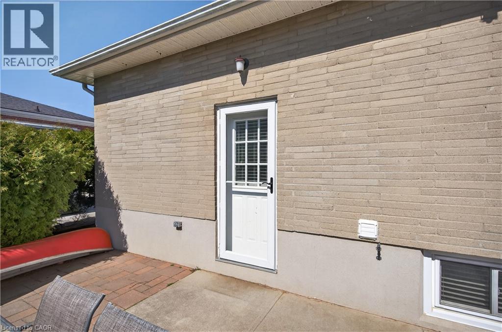 Exterior wall featuring light-colored brickwork and a white exterior door with a windowpane grid