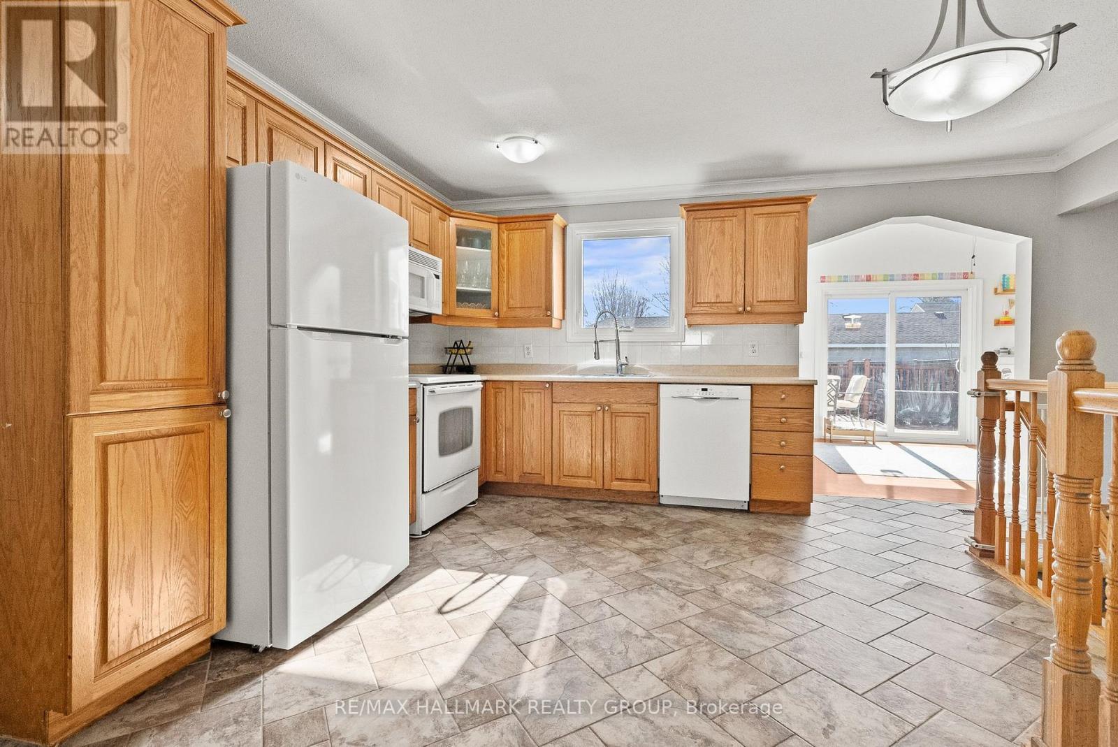 Kitchen open to sun-filled addition