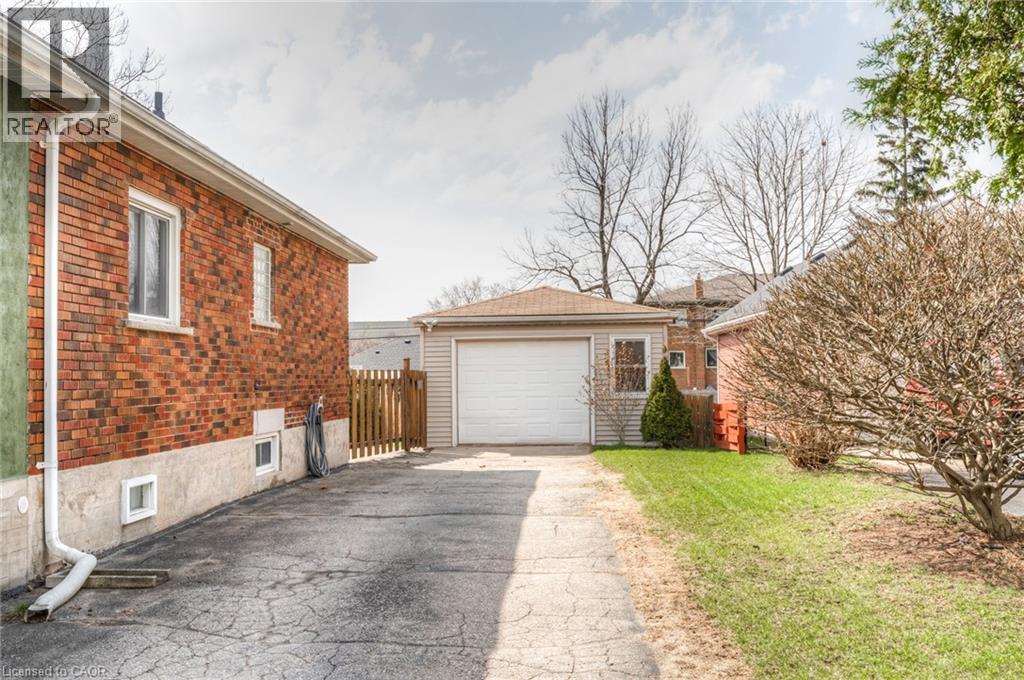 Detached garage with a white overhead door and siding exterior