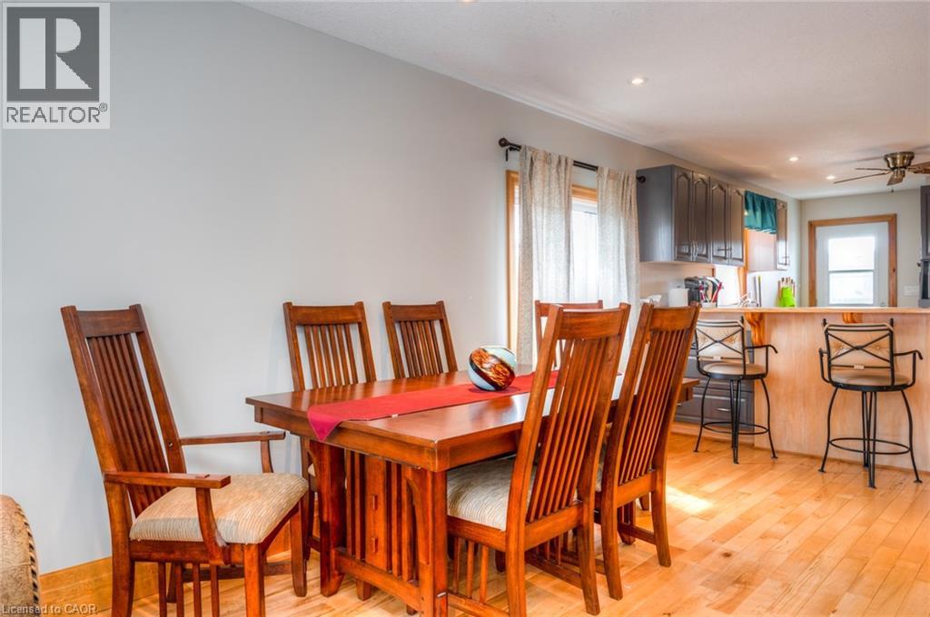 Dining area featuring wood-finish flooring, recessed lighting, and a window with natural wood trim
