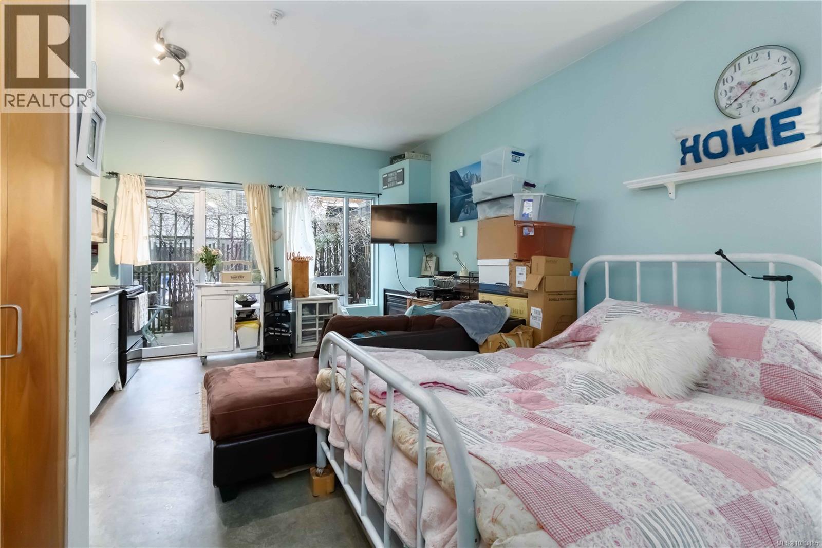 Bedroom with access to exterior and finished concrete floors