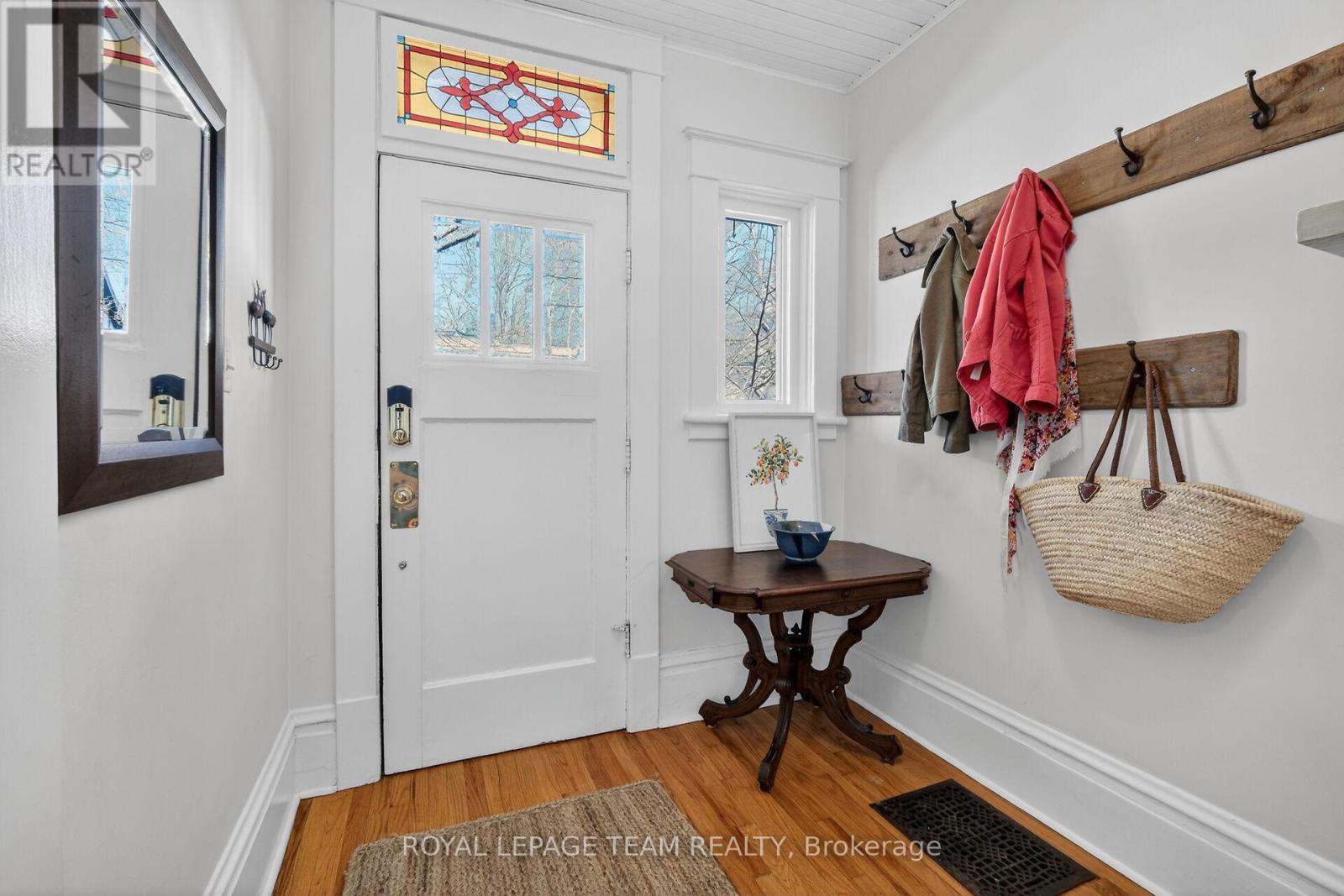 Foyer front door with stained glass transom window