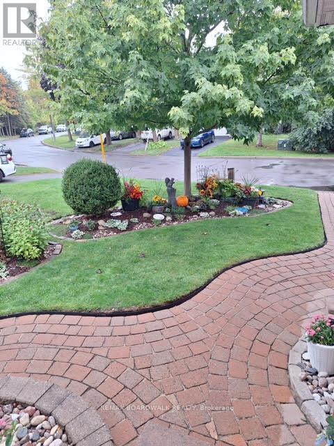 A summer photo of the front walkway and garden!