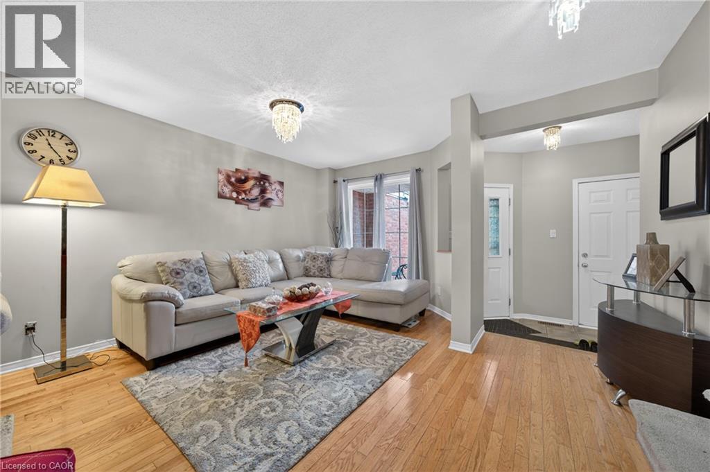 Hardwood flooring and light gray walls define this living space