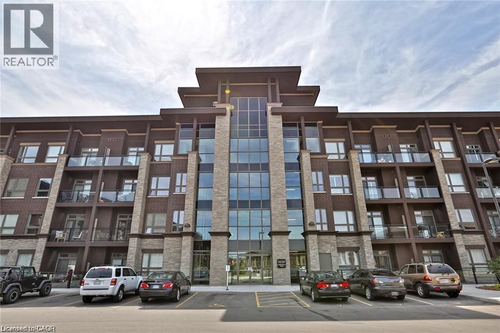 Multi-story residential building featuring a brick and stone facade