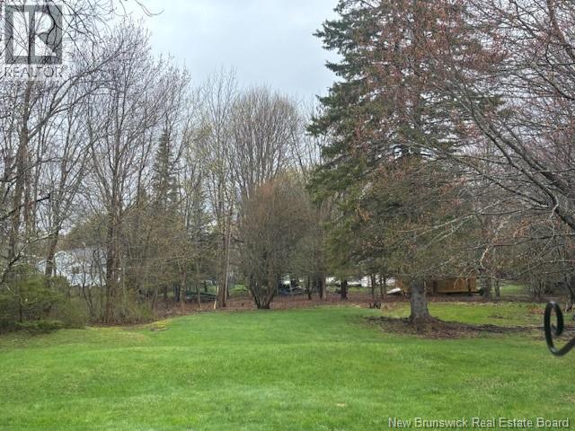 Handsome private yard surrounded by mature trees.