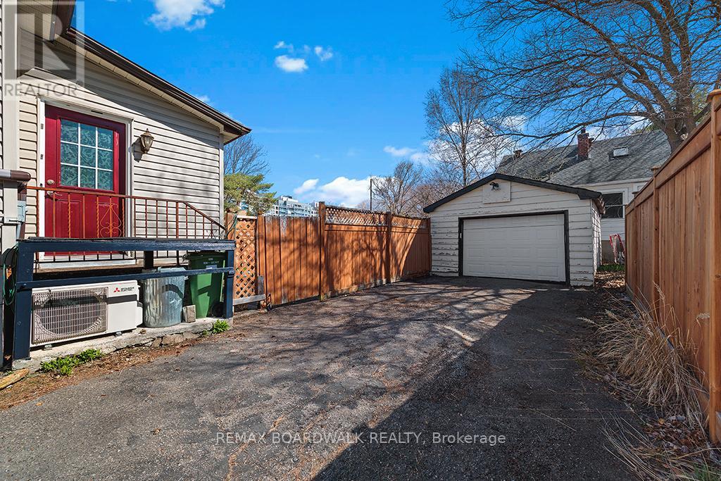 Featuring a large driveway and detached garage
