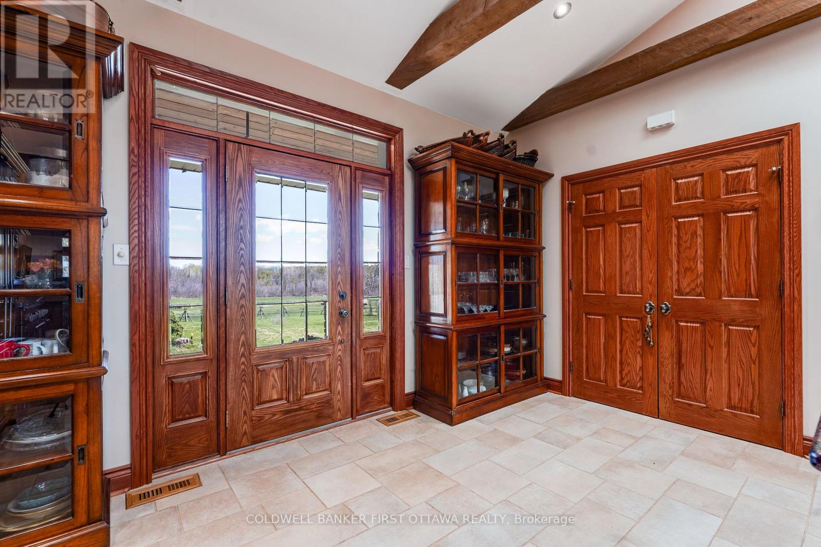 Impressive front foyer with rich oak door & trim
