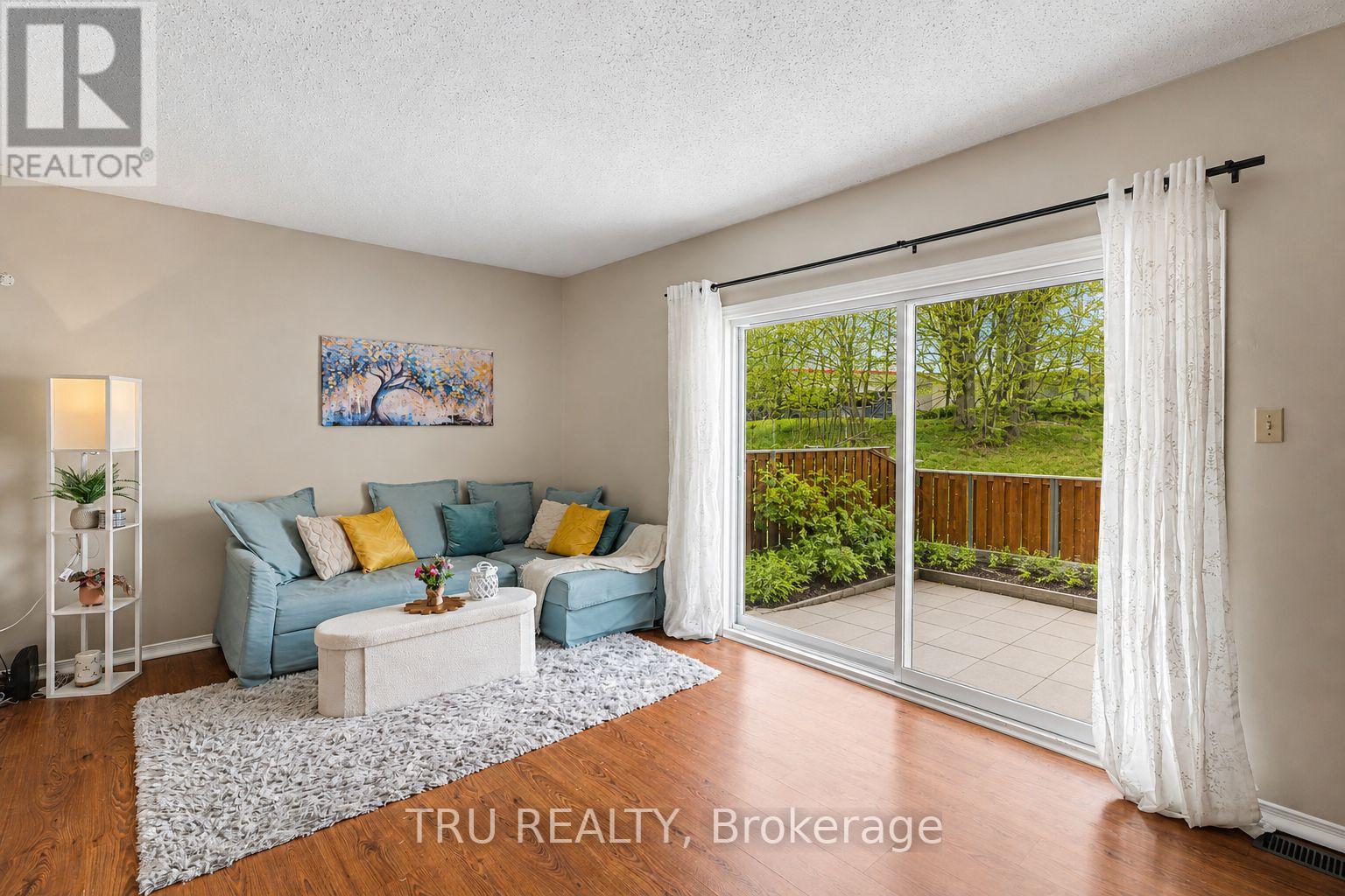 Warm inviting living rm extending to private yard