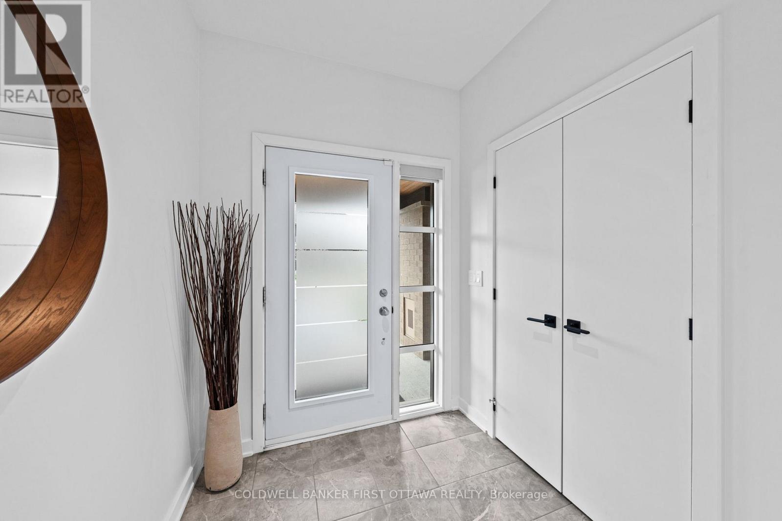 Welcoming front foyer w ceramic tile.