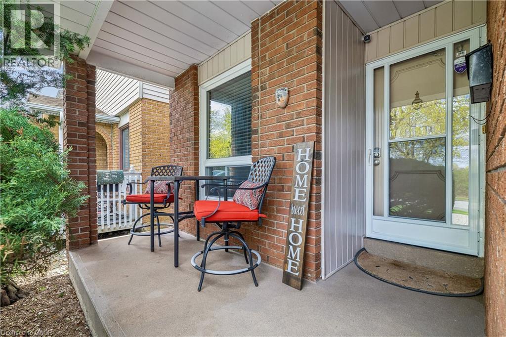 Covered front porch featuring brick columns and a white soffit