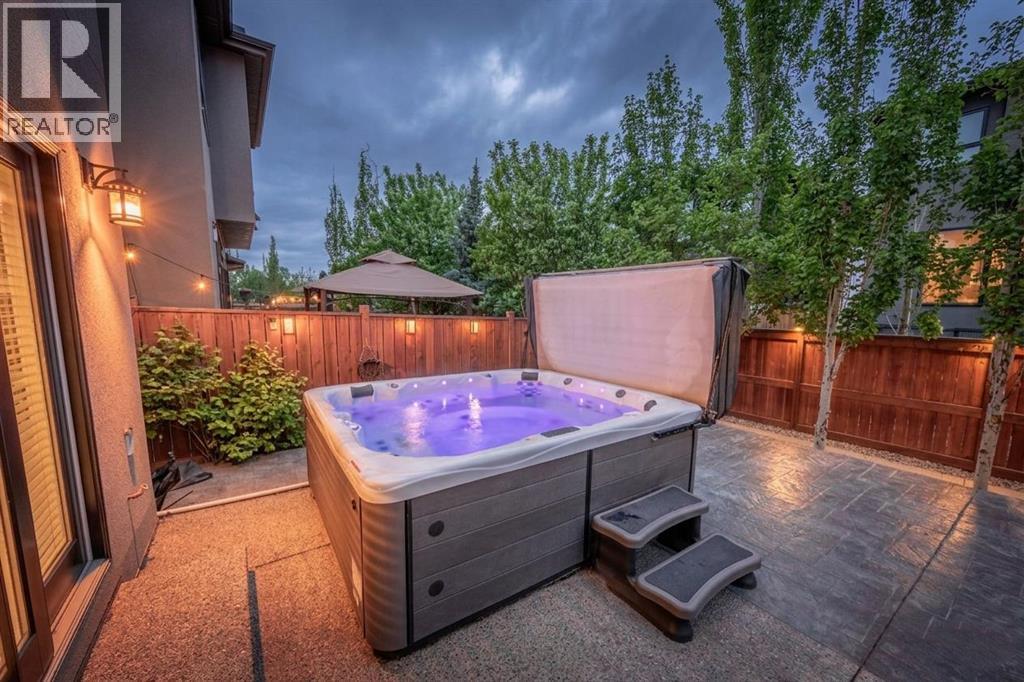 Backyard with hot tub and mature trees